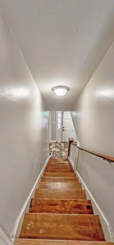 a view of an empty room and wooden floor