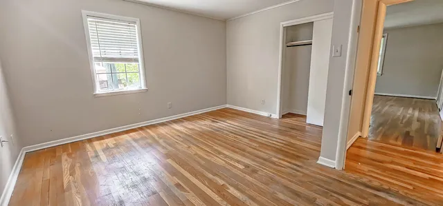 wooden floor in an empty room with a window