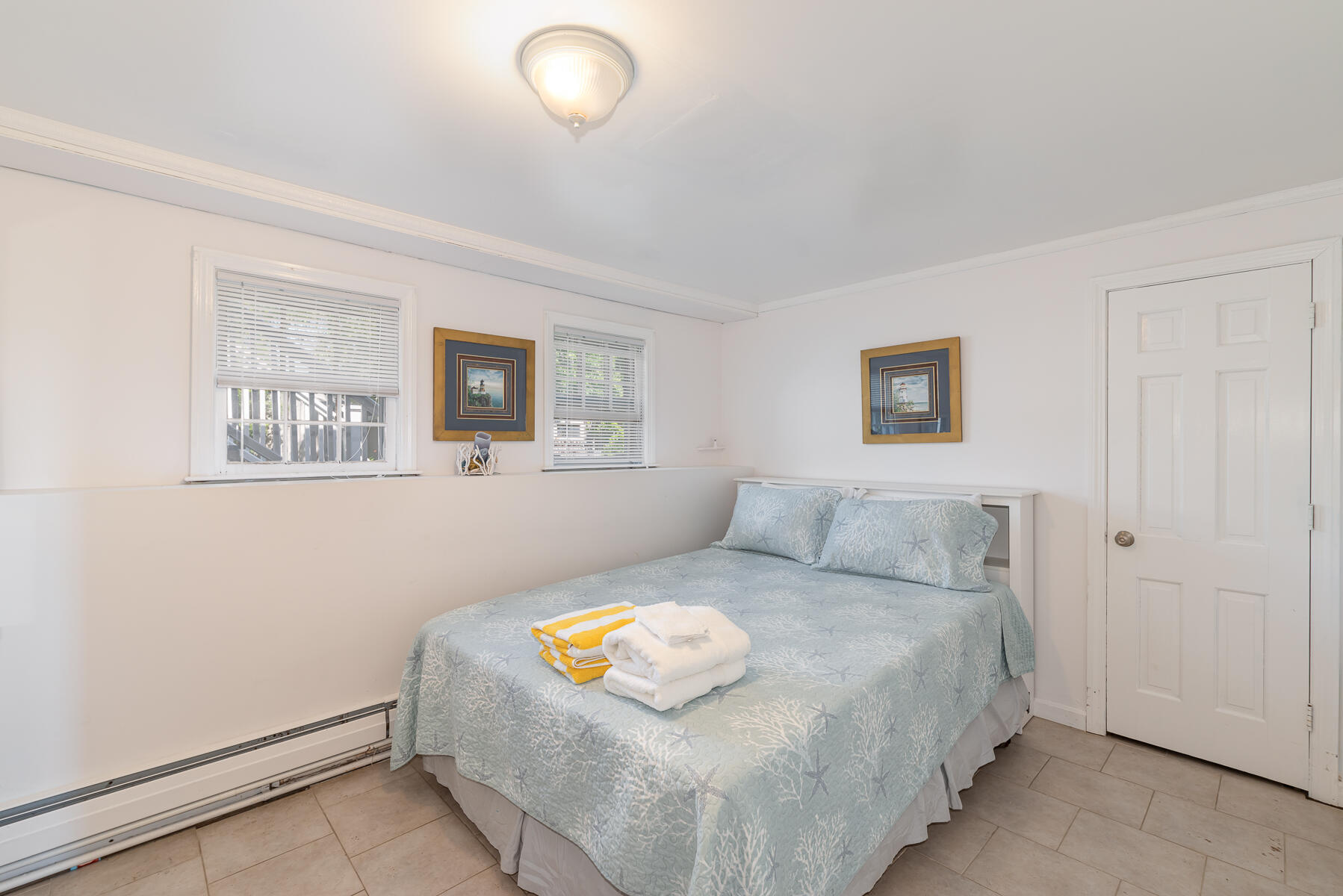90 Ripple Cove Road Hyannis, MA 02601 - Photo 23 of 38 a bedroom with a bed and a painting on the wall