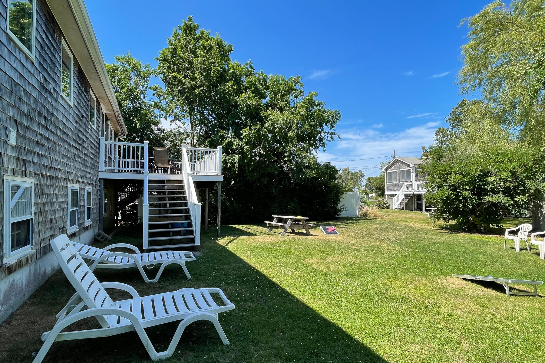 90 Ripple Cove Road Hyannis, MA 02601 - Photo 34 of 38 a view of a chairs and backyard with a barbeque grill and plants