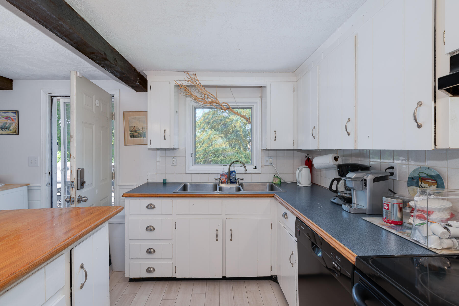 90 Ripple Cove Road Hyannis, MA 02601 - Photo 9 of 38 a kitchen with cabinets appliances a sink a faucet and a window