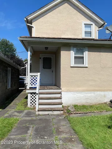 a view of a house with a small yard and plants
