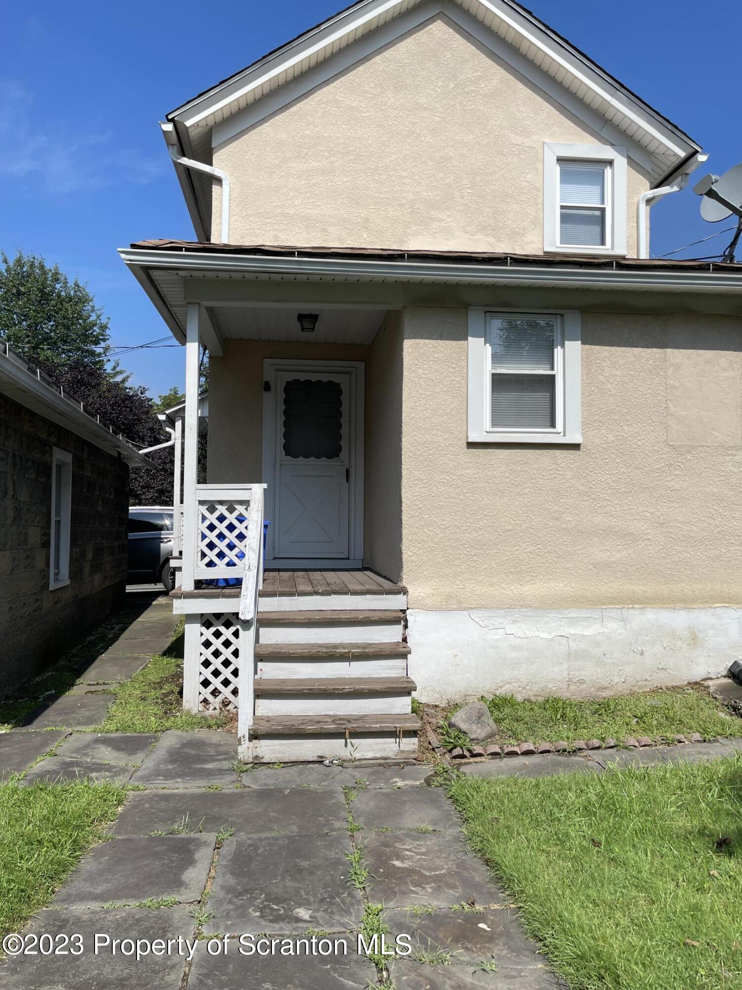 a view of a house with a small yard and plants