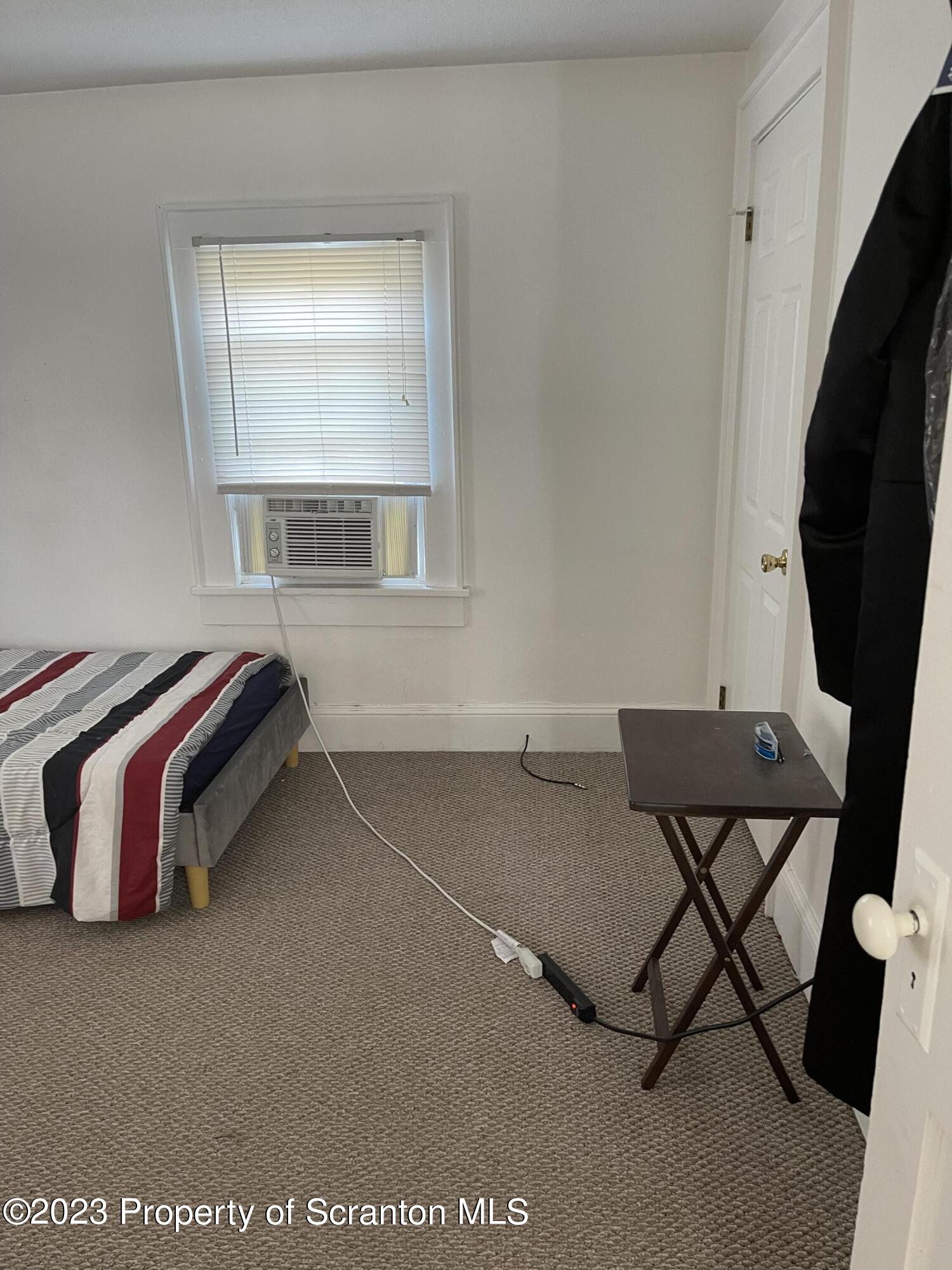 302 Rear Delaware Street Archbald, PA 18403 - Photo 14 of 20 a bedroom with a bed and a window