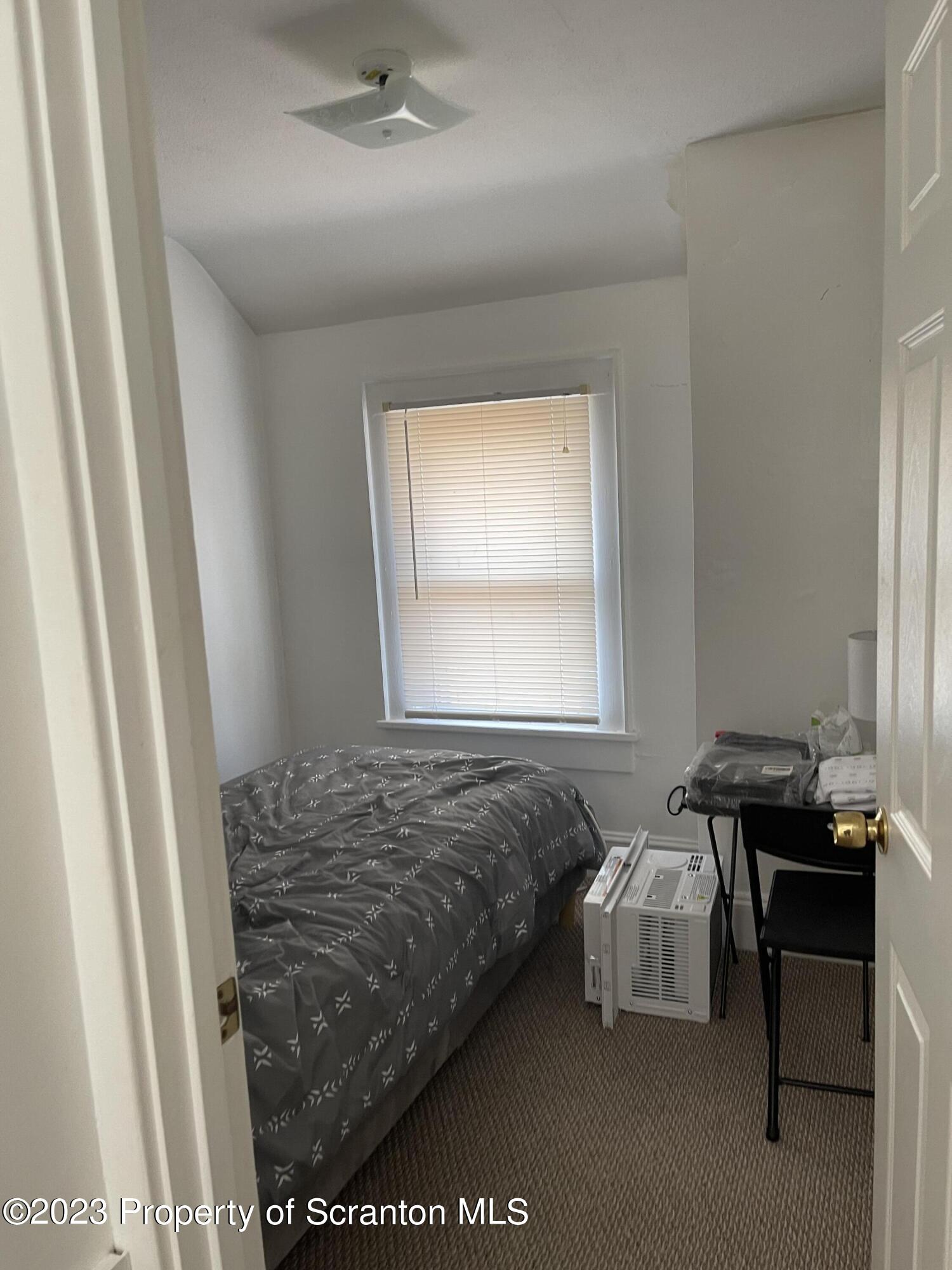 302 Rear Delaware Street Archbald, PA 18403 - Photo 15 of 20 a bedroom with a bed and a window