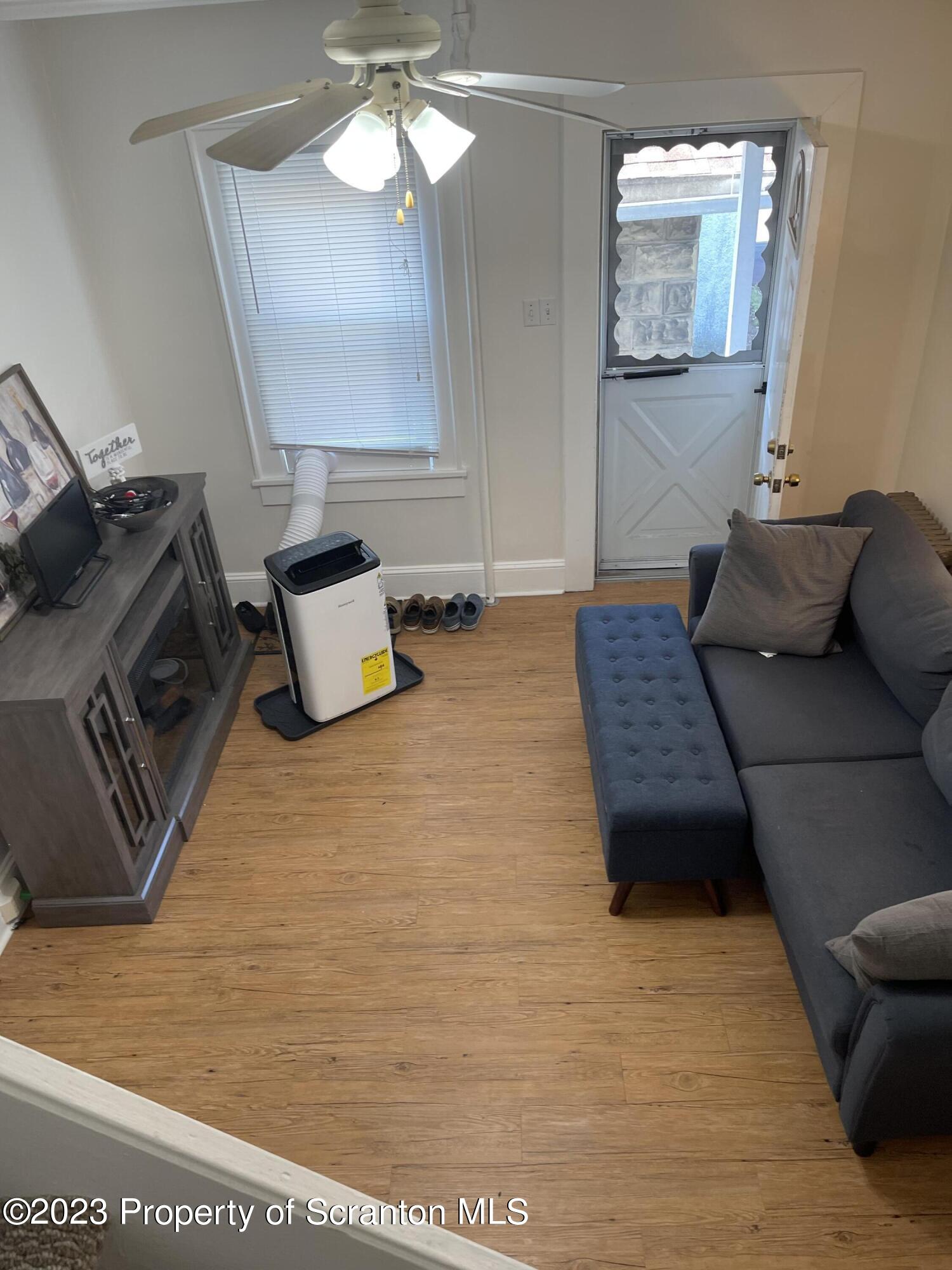 302 Rear Delaware Street Archbald, PA 18403 - Photo 8 of 20 a living room with furniture and a rug