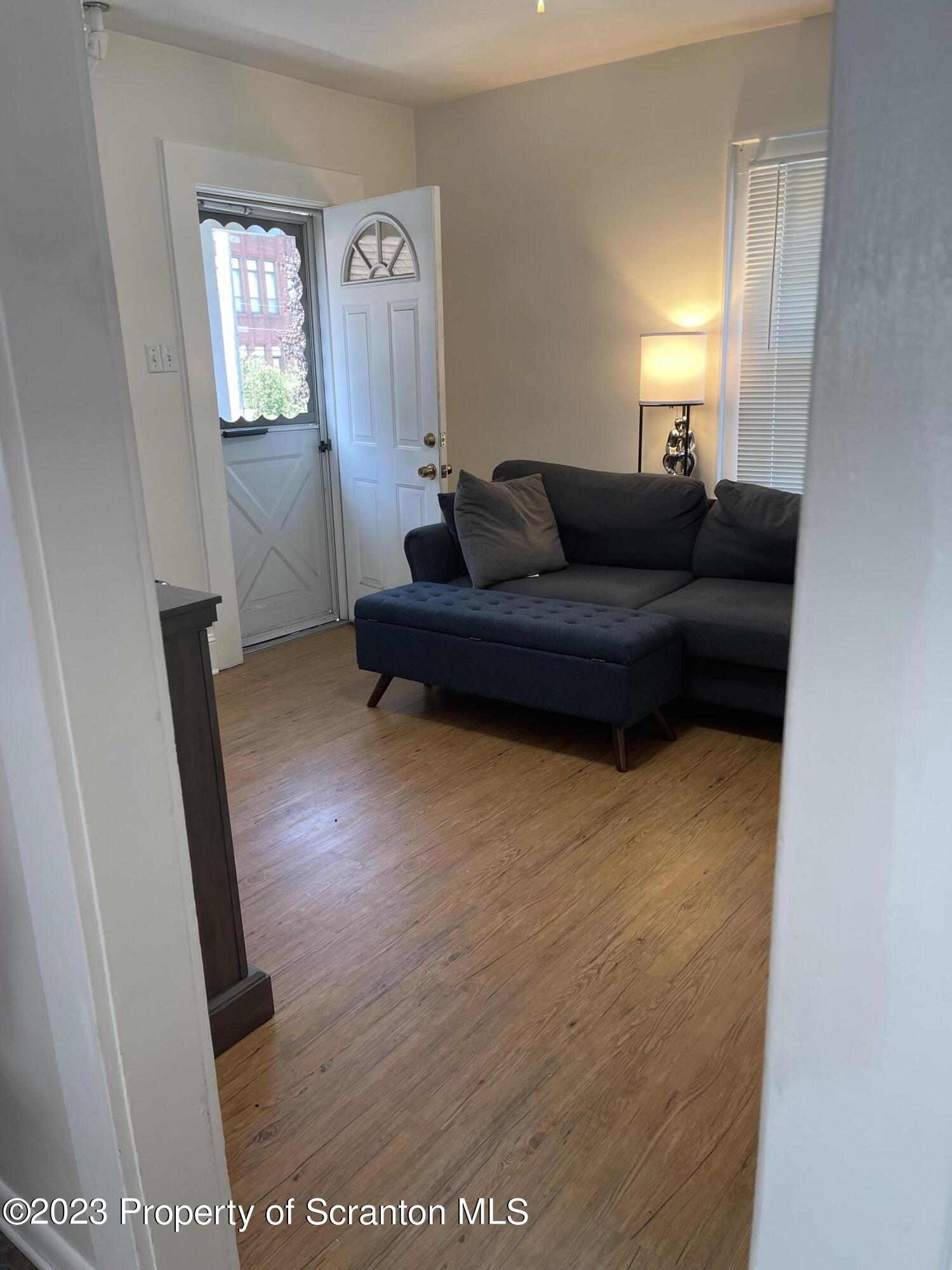 302 Rear Delaware Street Archbald, PA 18403 - Photo 9 of 20 a living room with furniture and a window
