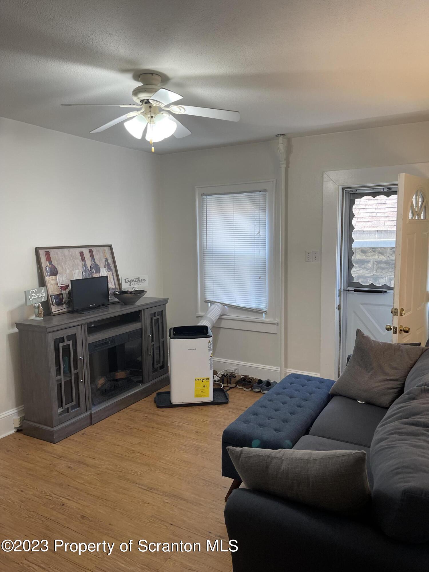 302 Rear Delaware Street Archbald, PA 18403 - Photo 10 of 20 a living room with furniture and a fireplace