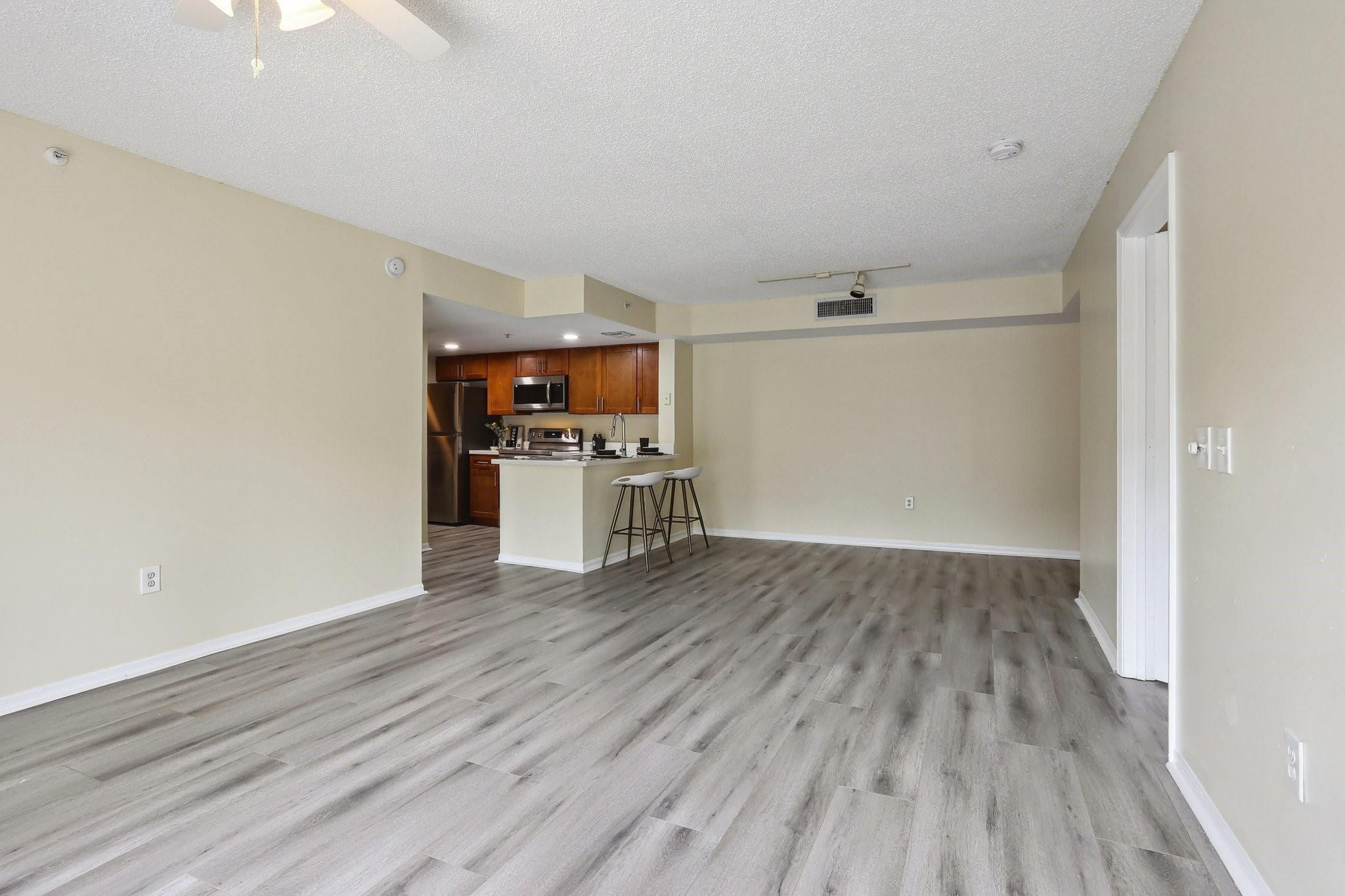 5051 Wiles Road, Unit 201 Coconut Creek, FL 33073 - Photo 12 of 41 a view of empty room with wooden floor