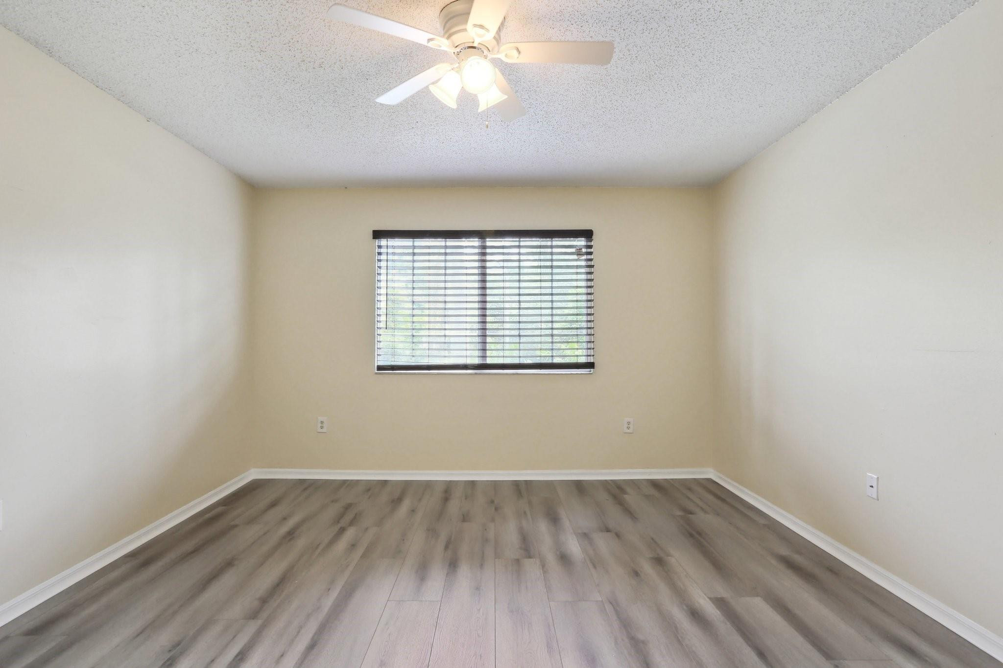 5051 Wiles Road, Unit 201 Coconut Creek, FL 33073 - Photo 15 of 41 wooden floor in an empty room with a window
