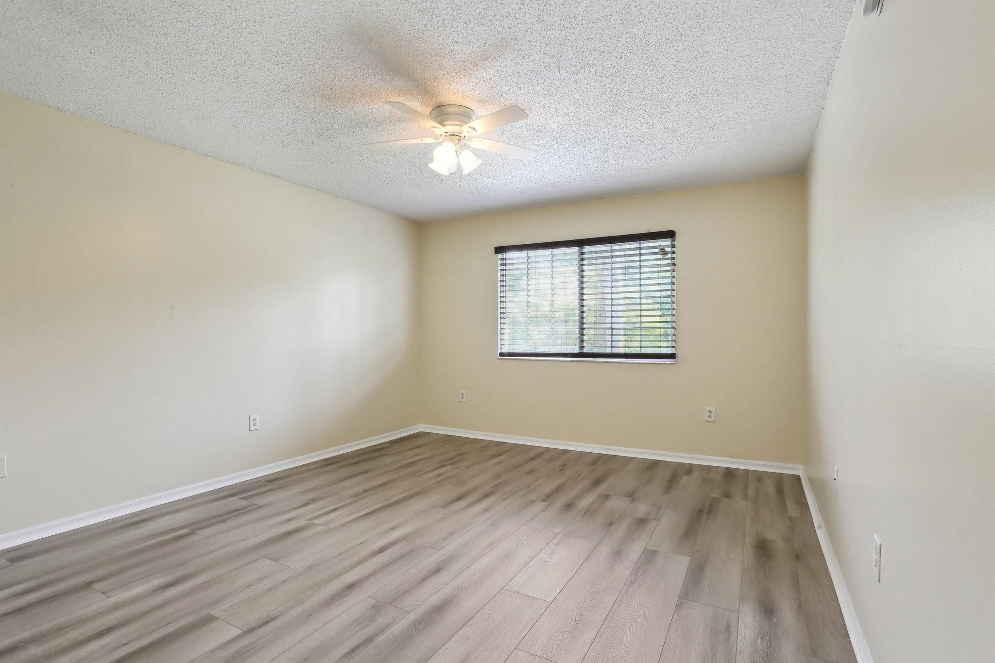 5051 Wiles Road, Unit 201 Coconut Creek, FL 33073 - Photo 16 of 41 wooden floor in an empty room with a window