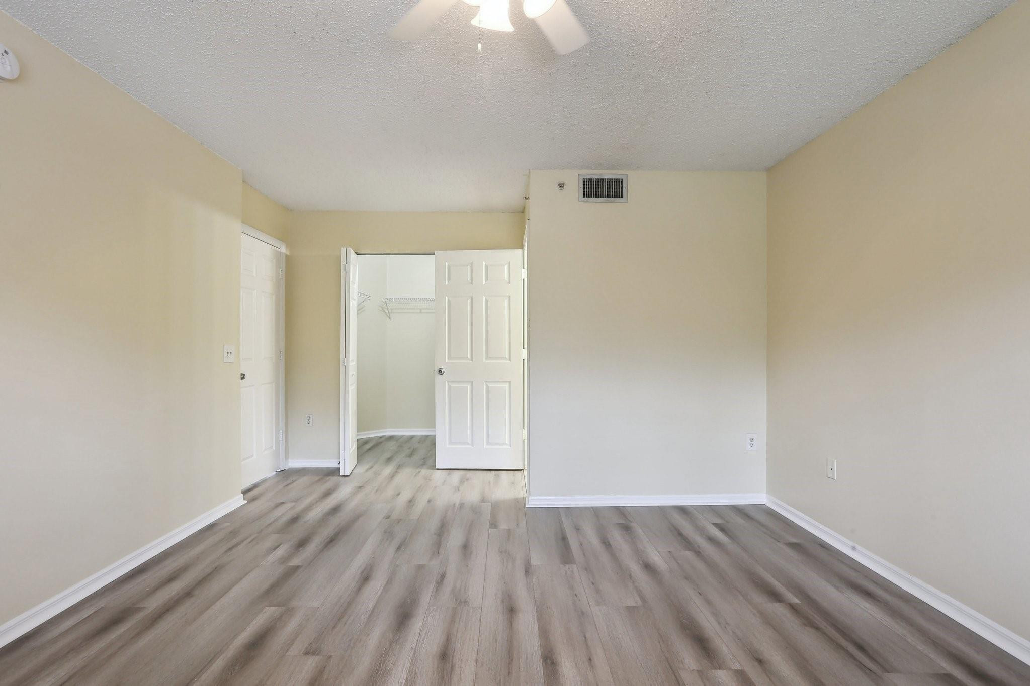 5051 Wiles Road, Unit 201 Coconut Creek, FL 33073 - Photo 17 of 41 wooden floor in an empty room with a window