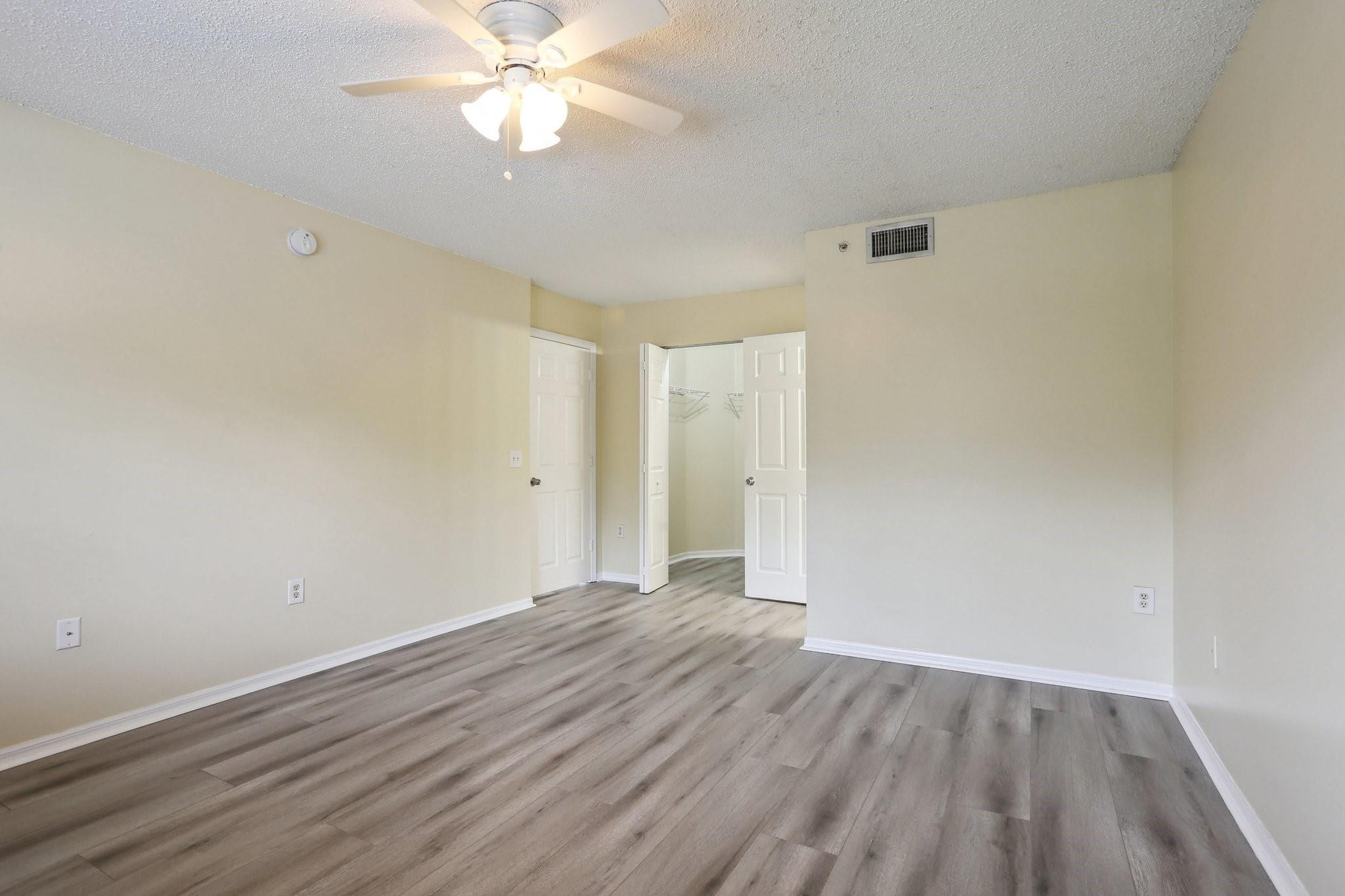 5051 Wiles Road, Unit 201 Coconut Creek, FL 33073 - Photo 18 of 41 wooden floor in an empty room with a window