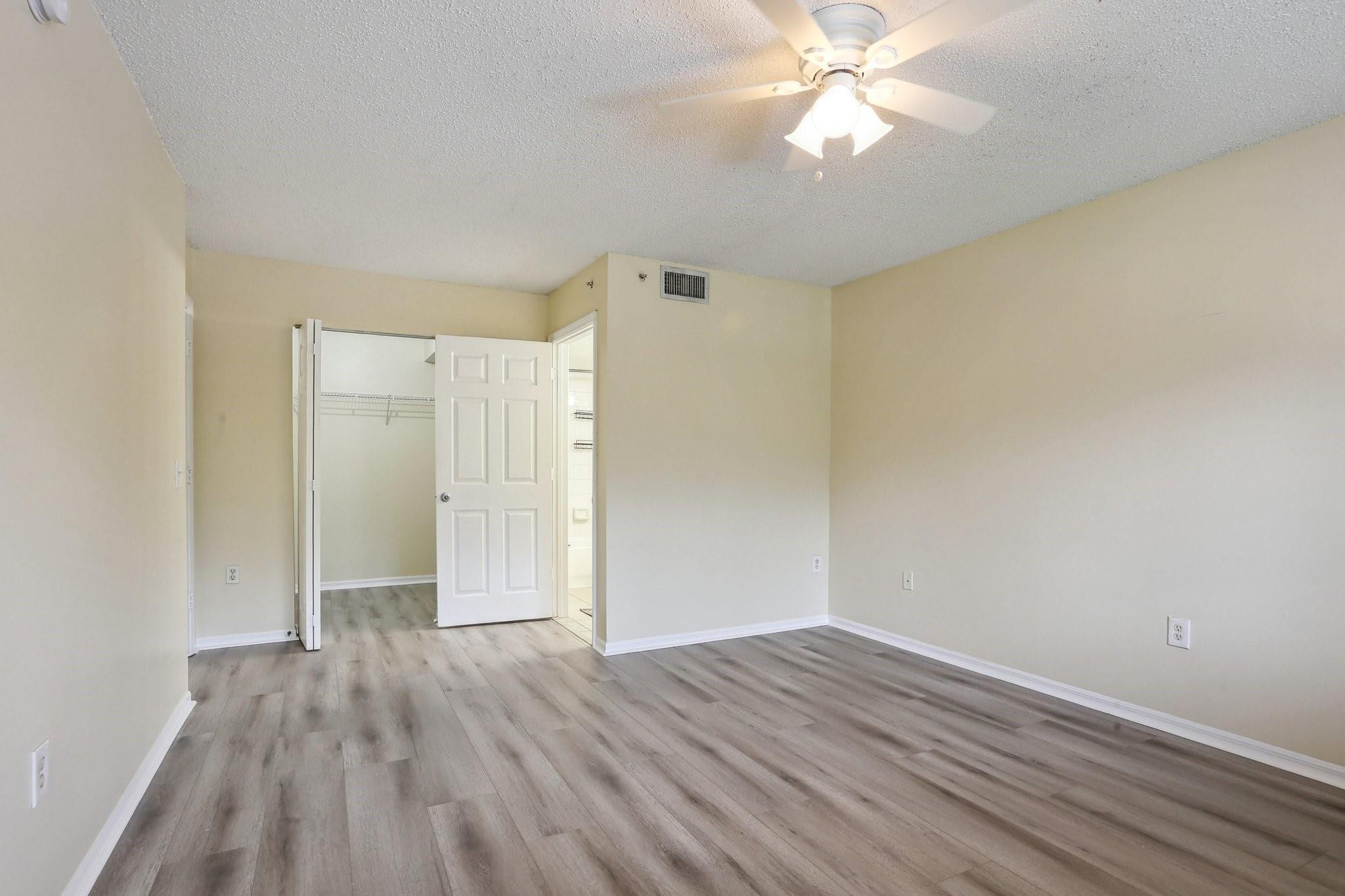 5051 Wiles Road, Unit 201 Coconut Creek, FL 33073 - Photo 19 of 41 wooden floor in an empty room with a window