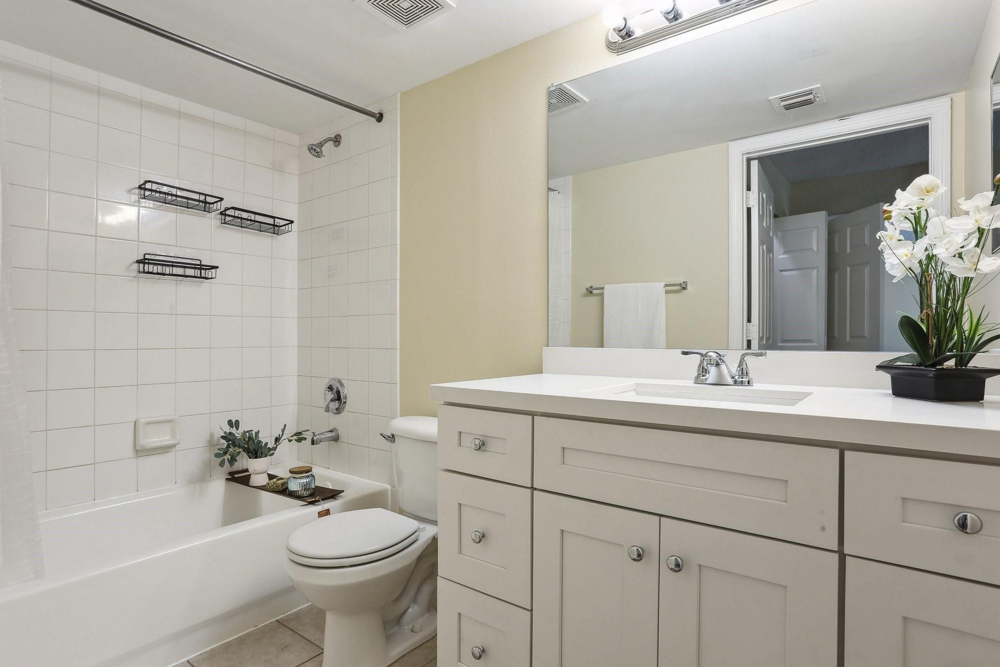 5051 Wiles Road, Unit 201 Coconut Creek, FL 33073 - Photo 20 of 41 a bathroom with a sink a toilet and shower
