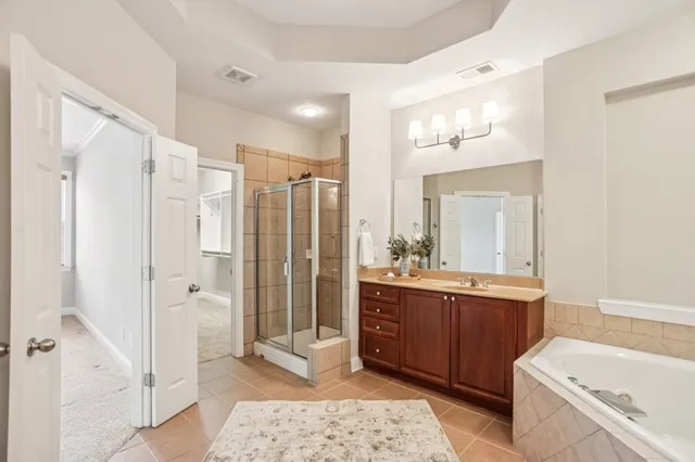 a bathroom with a tub sink and mirror