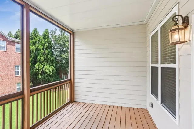 a view of a balcony with wooden floor