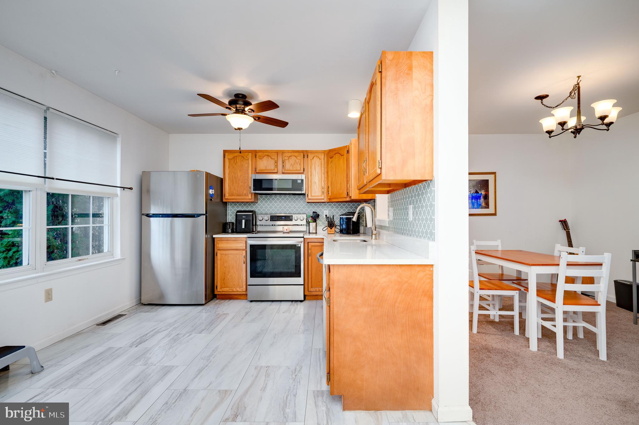 21-4 Cranberry Ridge, Unit 4 Reading, PA 19606 - Photo 6 of 41 a living room with stainless steel appliances kitchen island granite countertop furniture and a kitchen view