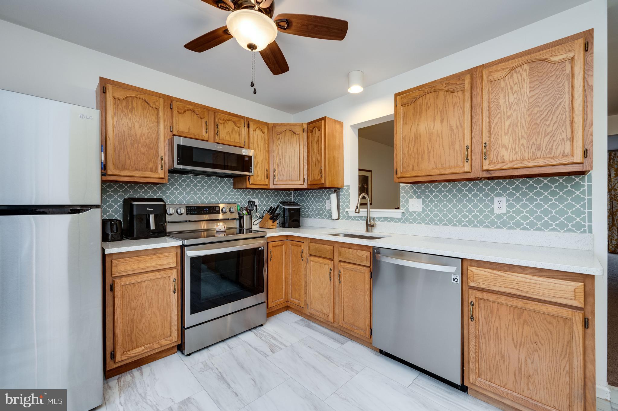21-4 Cranberry Ridge, Unit 4 Reading, PA 19606 - Photo 10 of 41 a kitchen with stainless steel appliances granite countertop a sink a stove and cabinets