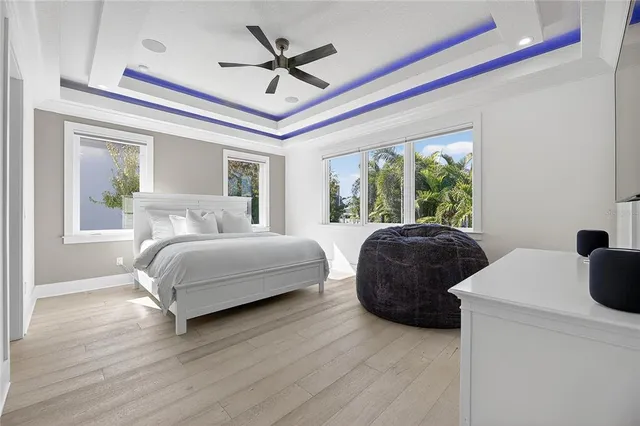 a large bed sitting in a bedroom next to a window