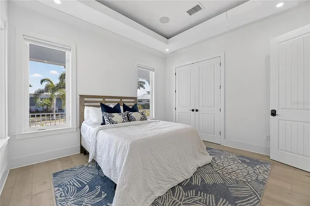 an aerial view of a city with lots of residential buildings ocean and mountain view in back