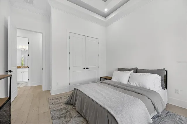 an aerial view of a house with a garden and lake view