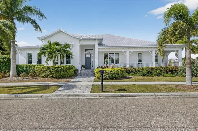 a view of a house with a yard and palm trees