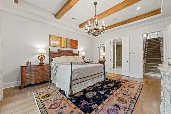 a bedroom with bed and wooden floor