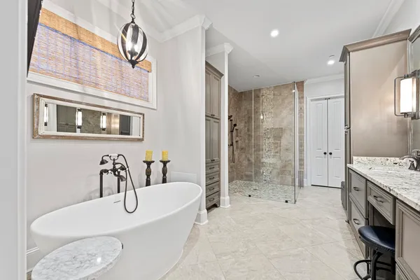 a bathroom with a granite countertop sink a toilet a mirror and shower