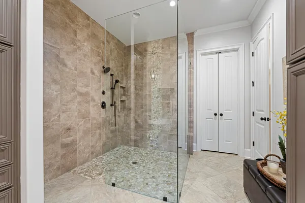 a bathroom with a shower and a glass door