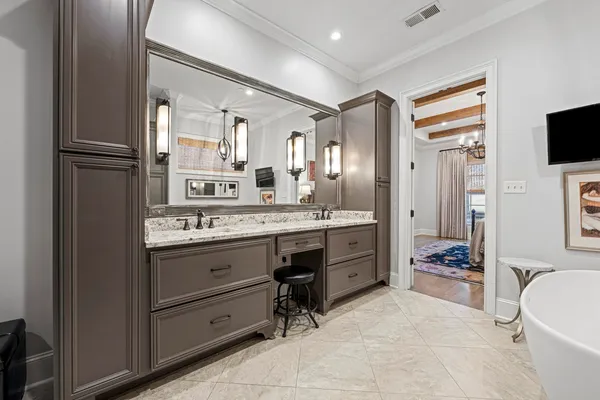 a spacious bathroom with a granite countertop sink mirror and bathtub