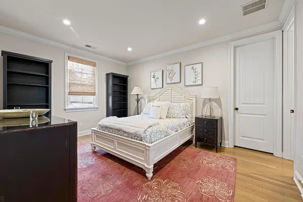 a spacious bedroom with a bed and a flat screen television