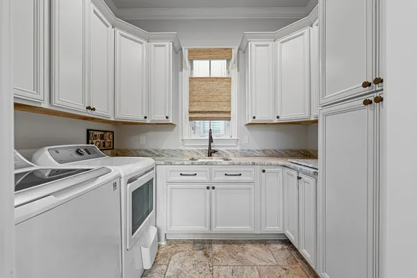 a kitchen with granite countertop cabinets sink and stove