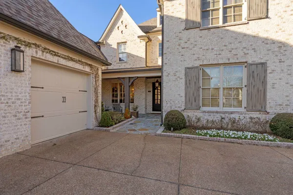 a view of a brick house with potted plants