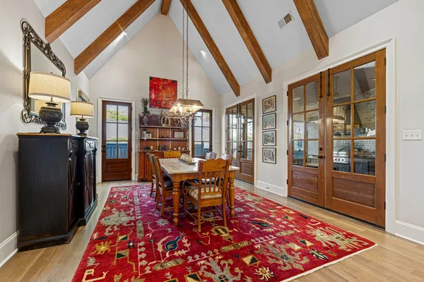 a living room with rug floor to ceiling windows and a rug