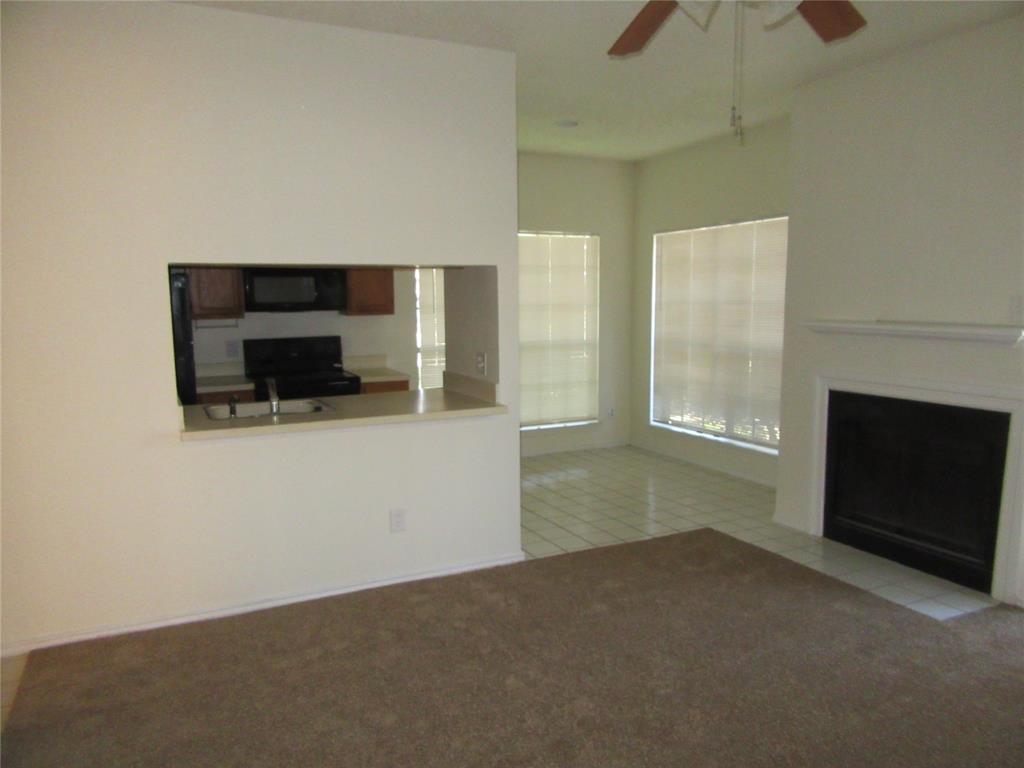 9737 Whitehurst Drive, Unit 39 Dallas, TX 75243 - Photo 1 of 5 a view of empty room with a fireplace and window
