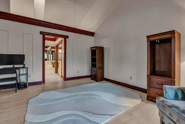 an aerial view of a house with a garden and lake view