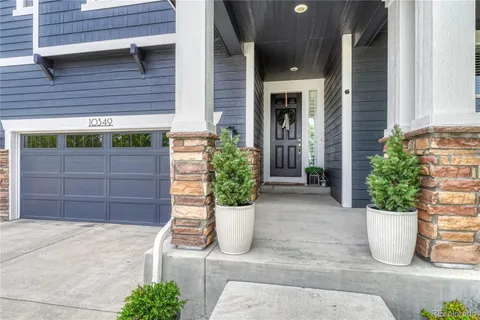 a view of a house with a potted plant and garage