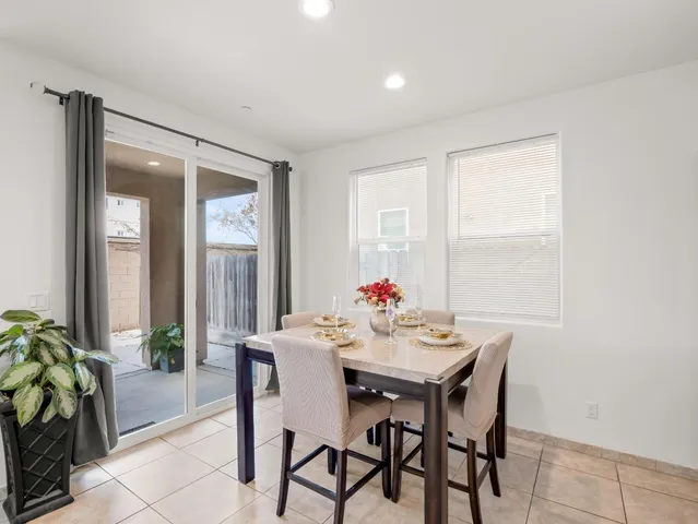 a view of a dining room with furniture and a potted plant