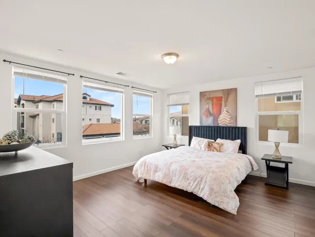 a bedroom with a large bed and a window