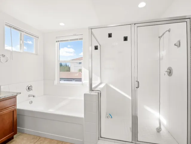 a bathroom with a bathtub shower and a sink