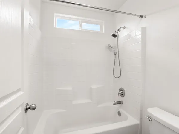 a view of a street with wooden fence