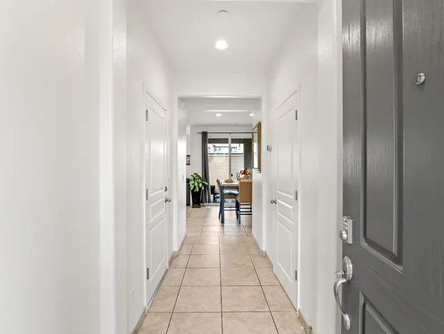 a hallway with dining table and chairs