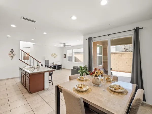 a kitchen with stainless steel appliances kitchen island granite countertop a stove a sink and a refrigerator