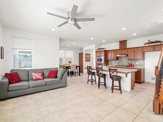 a living room with furniture and kitchen view