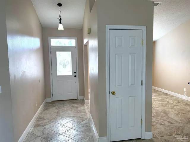 an empty room with closet and a bathroom