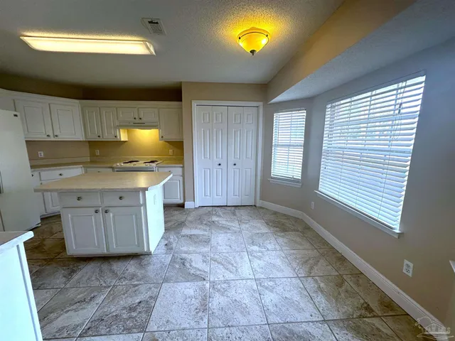 a kitchen with a sink cabinets and window