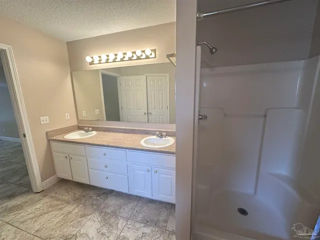 a bathroom with a double vanity sink and a mirror