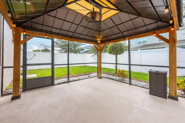 a view of a house with backyard and a tree