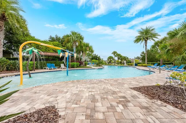 a view of a swimming pool with a table and chairs